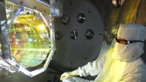 Laser Interferometer Gravitational Wave Observatory (LIGO) optics technician inspecting one of LIGO's core optics. Photo Credit: Caltech/MIT/LIGO Lab/AFP